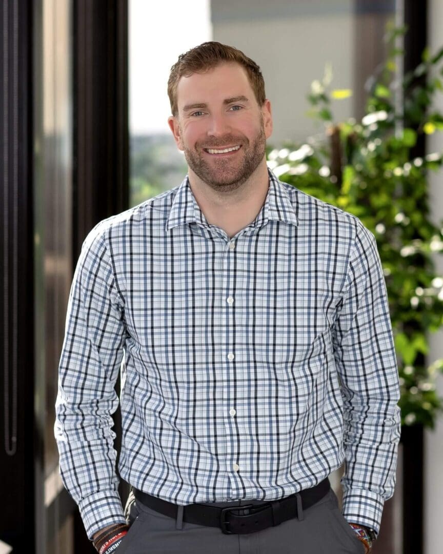A man standing in front of some trees