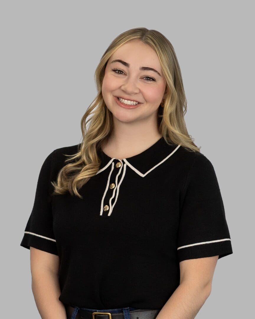 A woman in black shirt smiling for the camera.