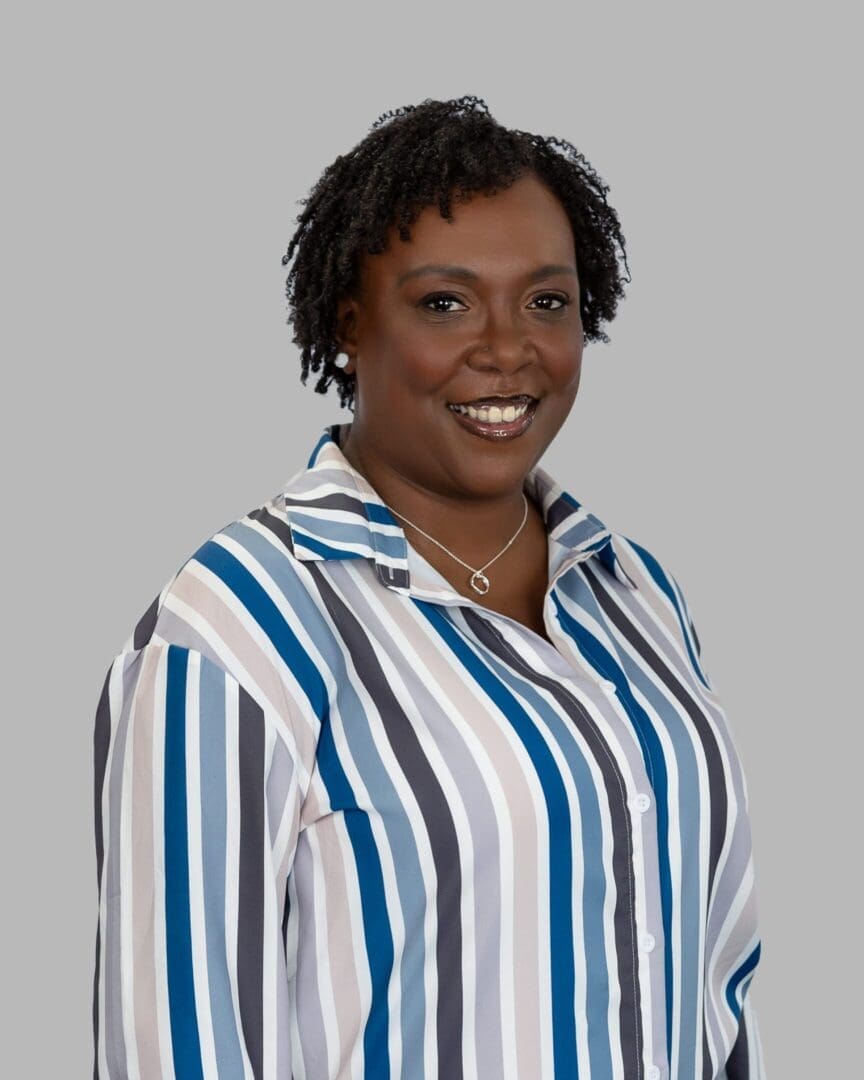 A woman in striped shirt smiling for the camera.