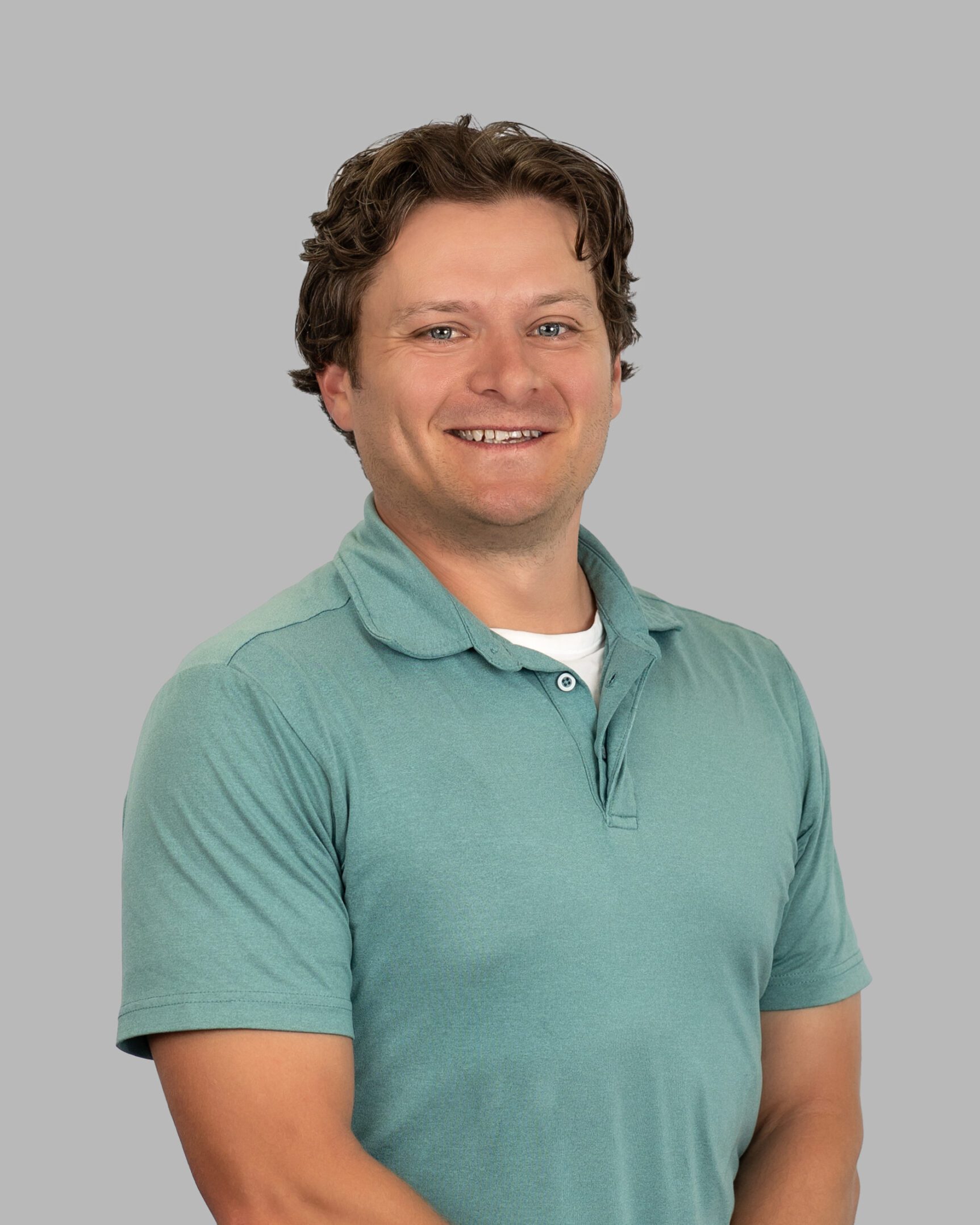 Jason_Sinecki-4-Print A man in a green shirt is smiling.