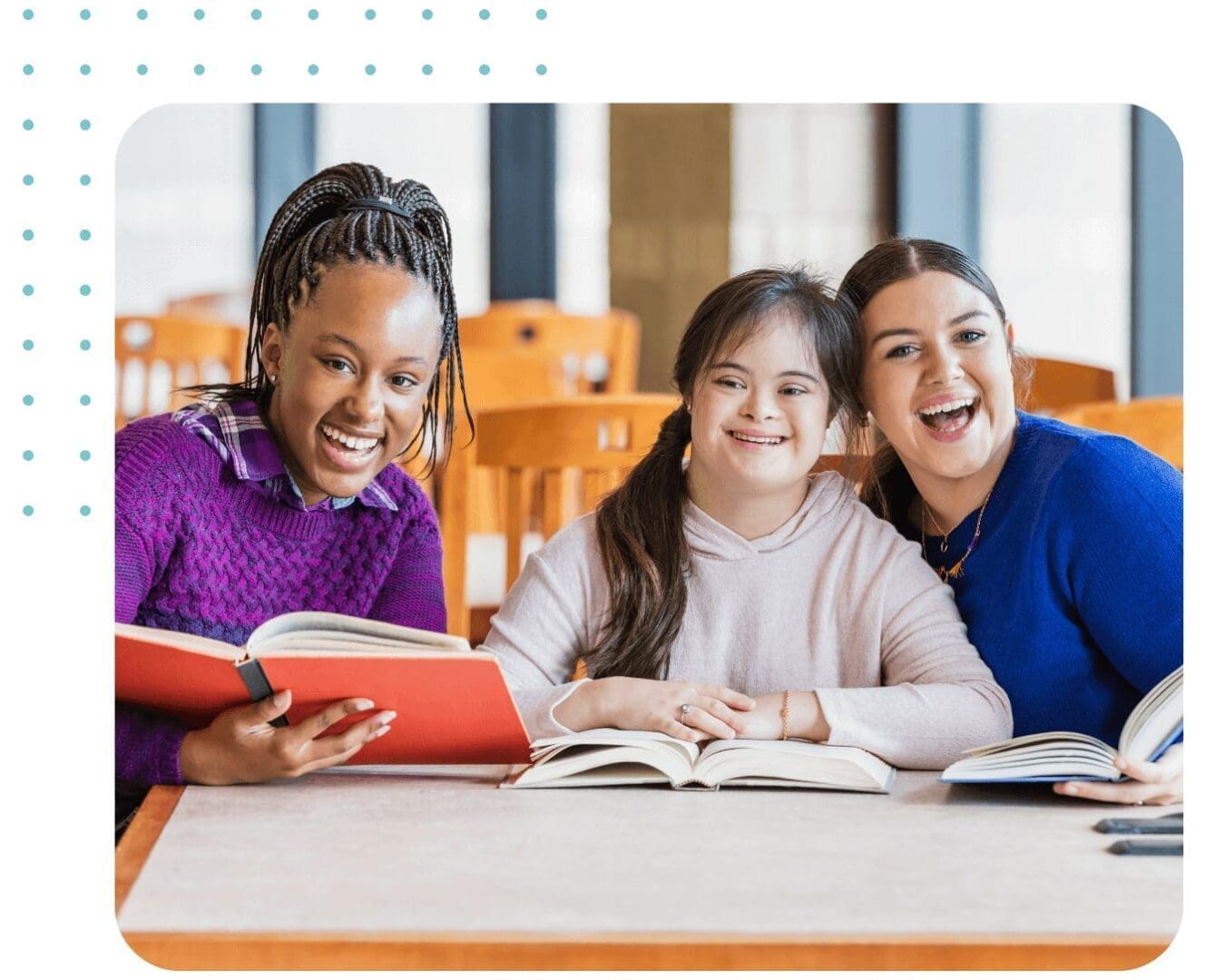 Three smiling friends reading books together.