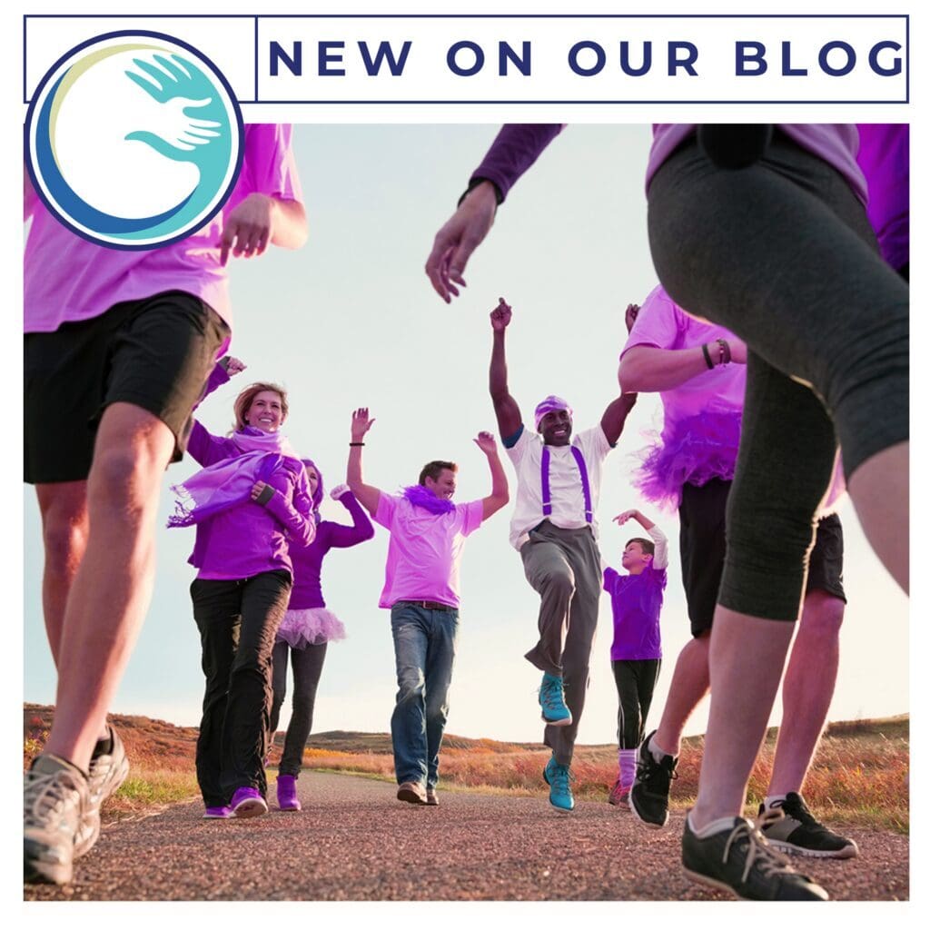 A group of people in purple shirts and black shorts.