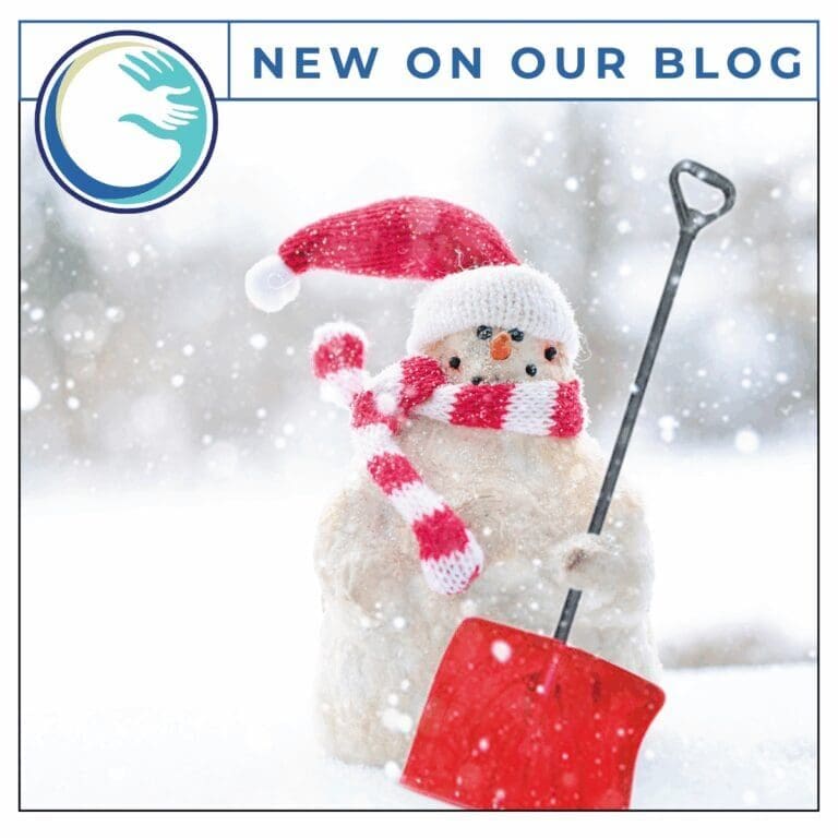 Snowman with red shovel and scarf.